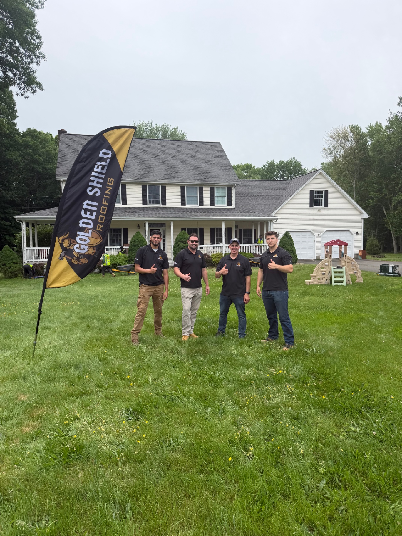 Golden Shield Roofing team in front of a Connecticut home